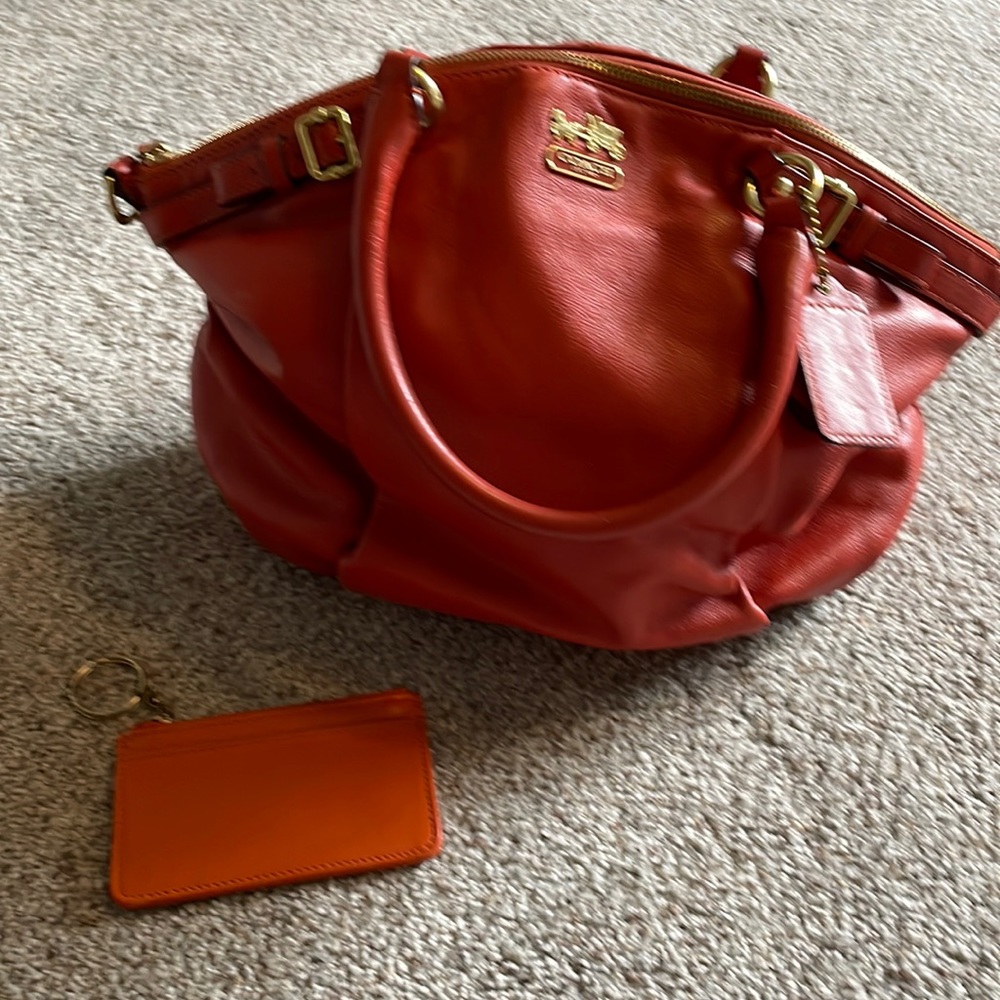 Coach burnt orange hand bag w/short double strap. Lots of pockets inside